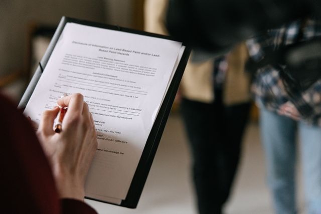 a person reviewing a lease agreement to sign