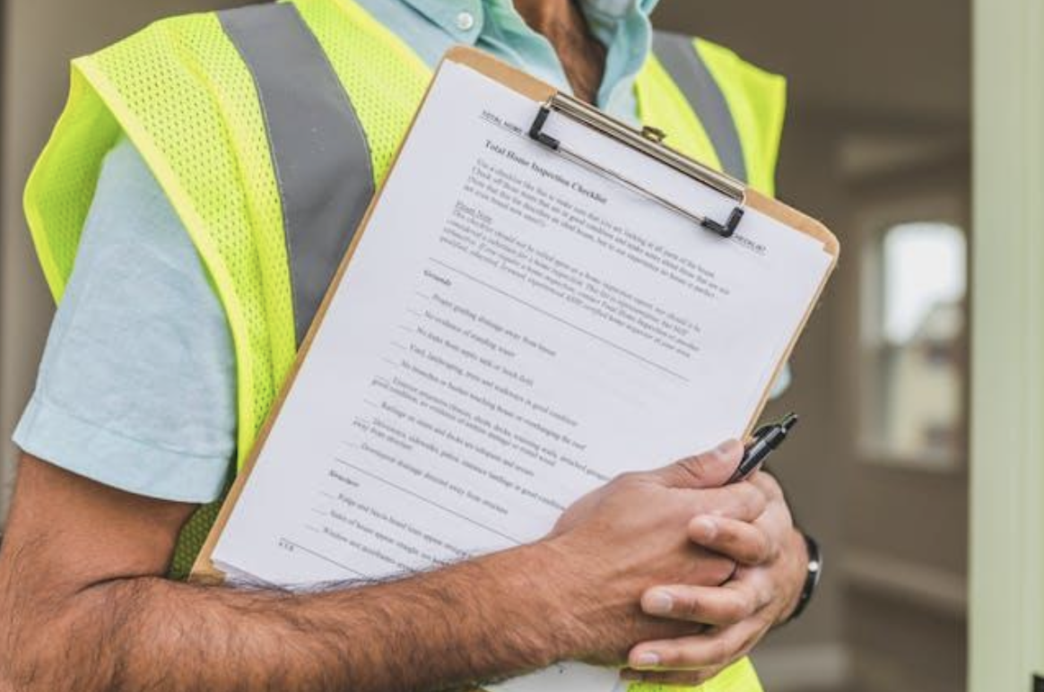 person holding home inspection checklist